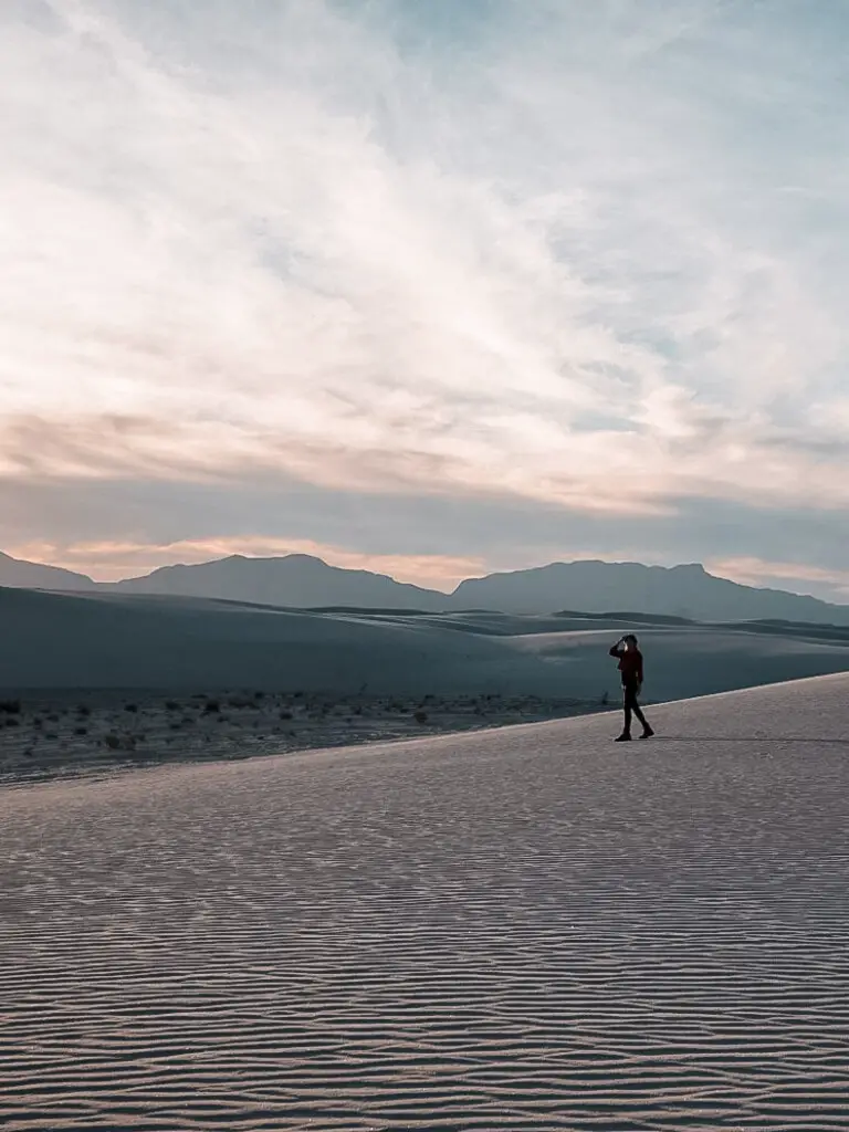Monica walking white sand dunes at sunset, a must see after your Albuquerque to Santa Fe Road Trip.