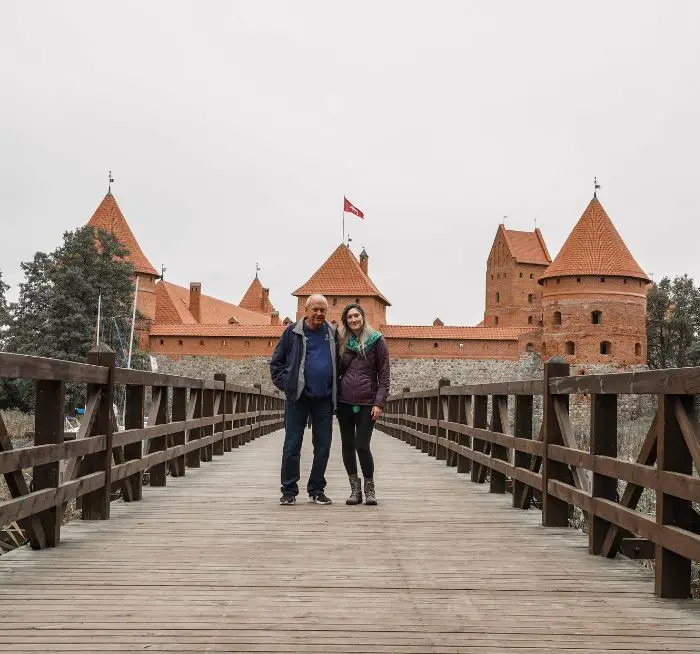 Monica and her father standing in front of Trakai Island Castle in Lithuania.