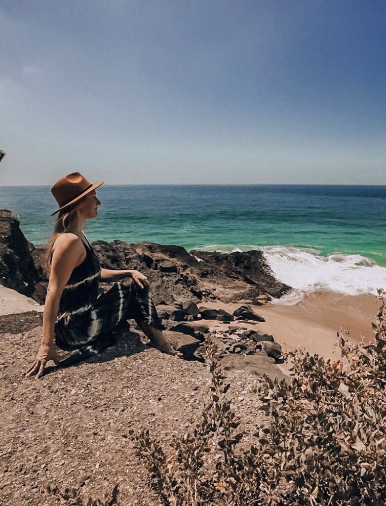 Monica at the beach in Malibu, a must see stop on any California to Arizona Road Trip.