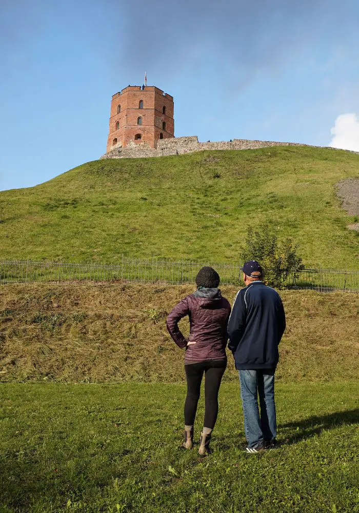 Monica and Peter gazing up at Gediminas Castle Tower in Vilnius.
