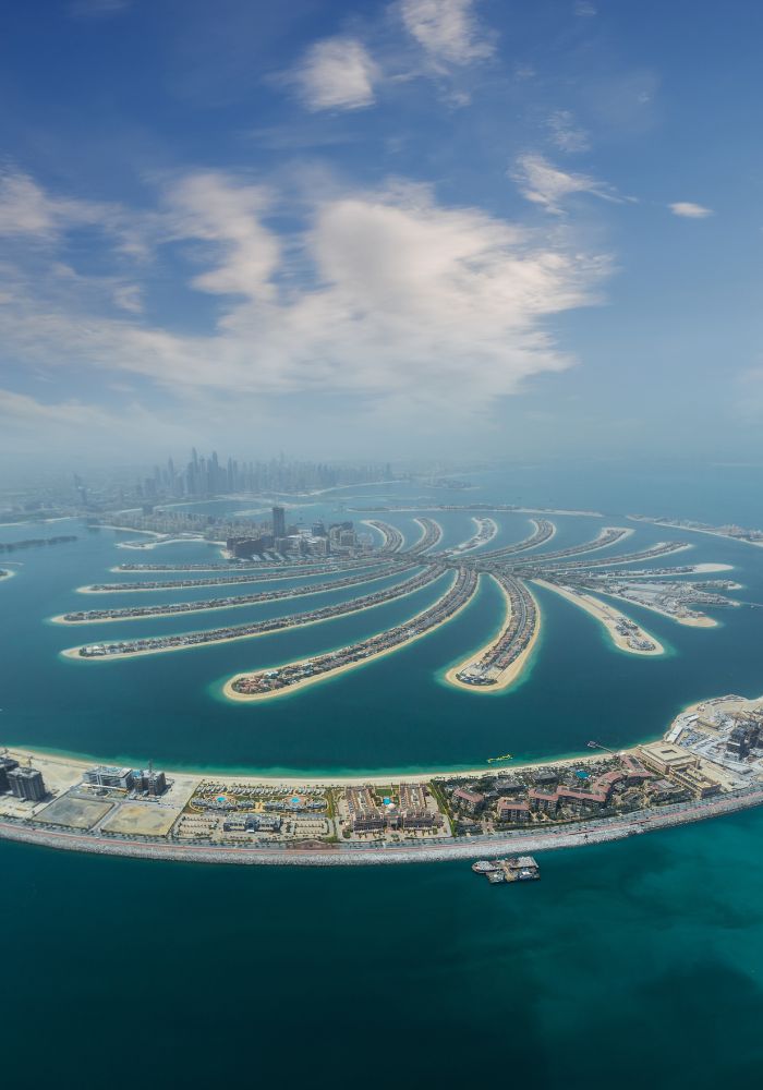 An aerial view of the palm-shaped Jumeirah island below.