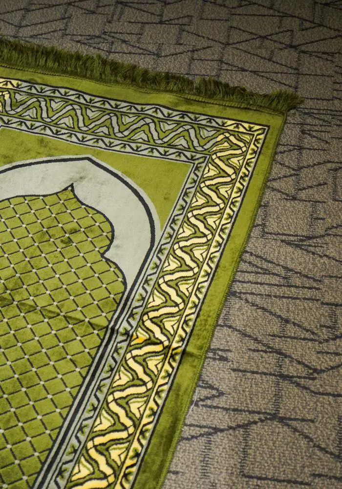 A green prayer rug for Muslims - who should not be disrespected when in Dubai. Ten things not to do in Dubai.