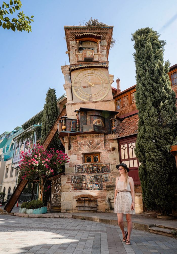 Monica in front of the famous clock tower, one of The Best Things to Do in Tbilisi, Georgia.