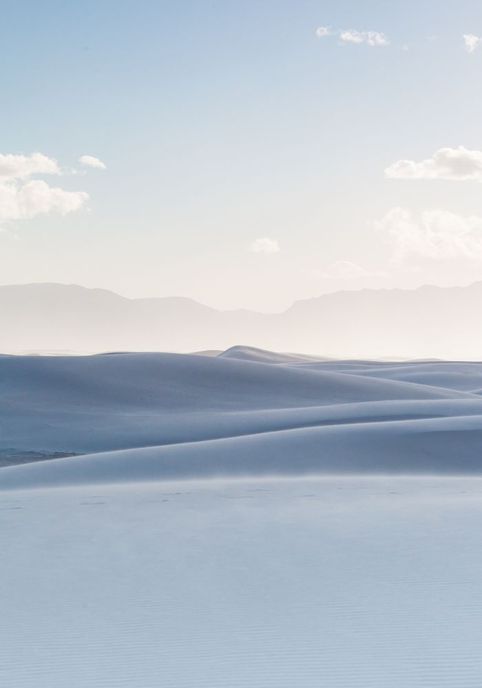 The rolling white sand dunes seen far off the hiking trails, one of the ebst Things to Do in White Sands National Park, New Mexico.