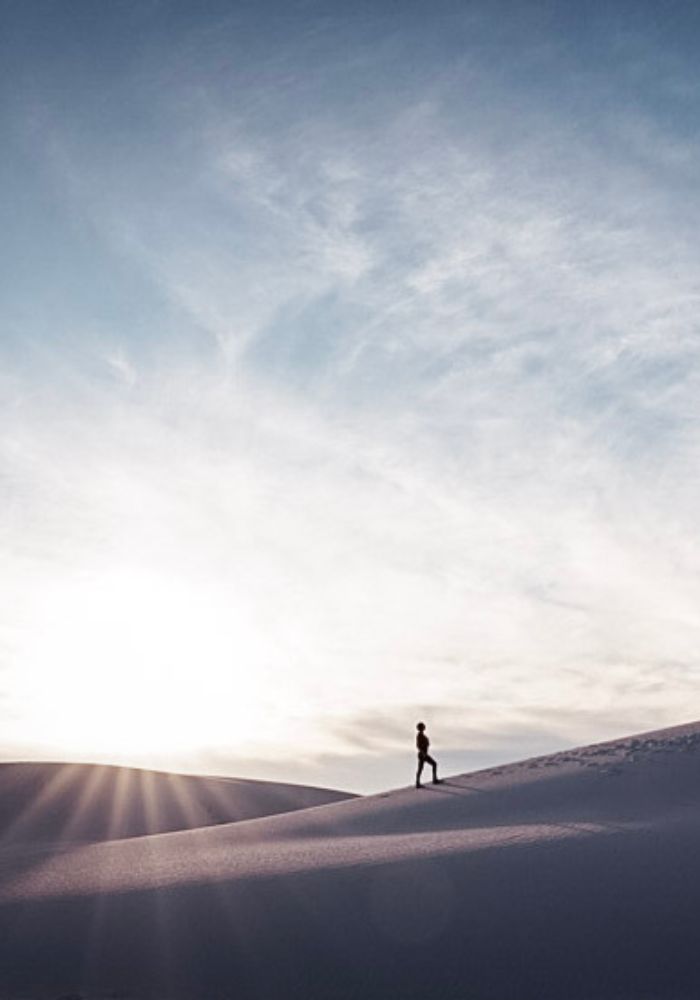 Monica walking up the sand dunes at White Sands National Park.