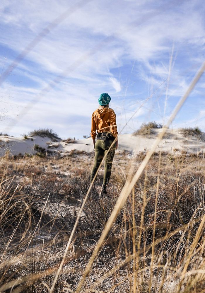 Monica exploring the desert vegetation on a hike, one of the best Things to Do in White Sands National Park, New Mexico.