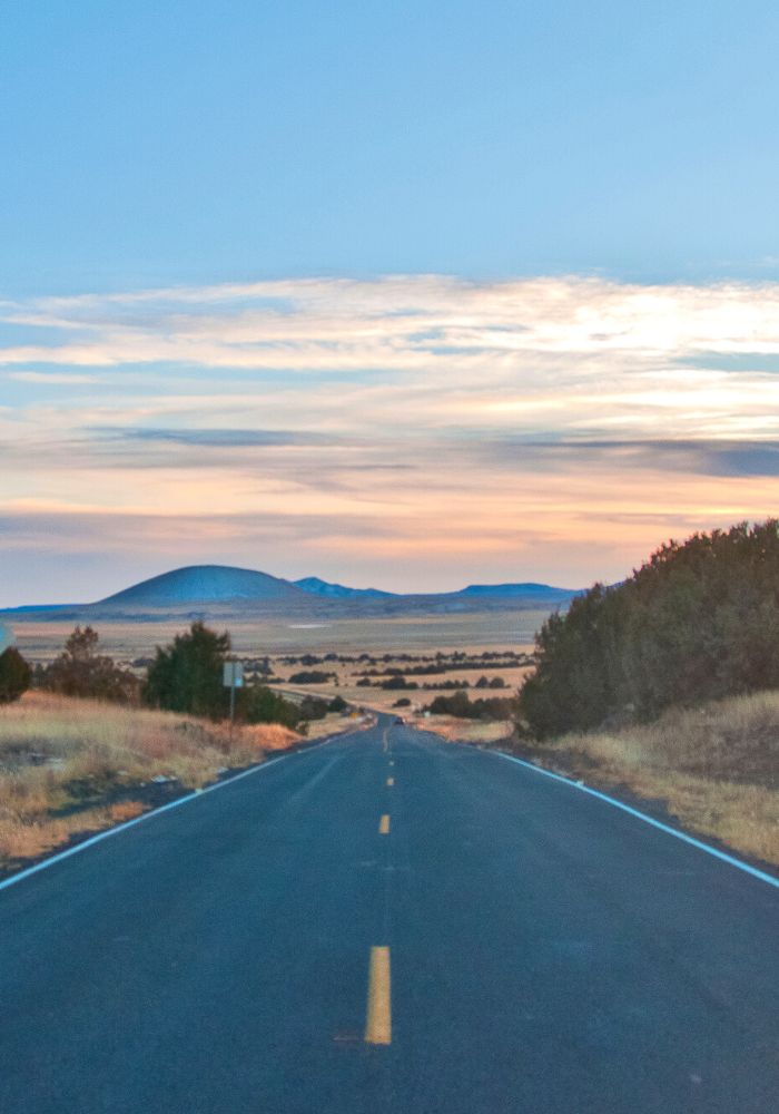 The road stretching out through the New Mexico desert, seen on a New Mexico Road Trip.