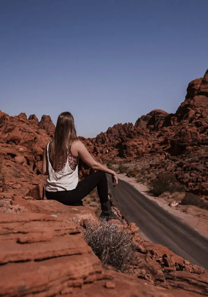 Things to Do on a Road Trip with Friends - Monica exploring the Valley of Fire.