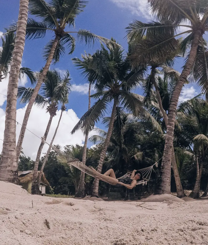 Monica underneath the palm trees on Saona Island - a Santo Domingo beach trip worth the trek!
