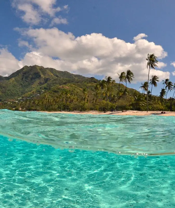 The clear blue water in front of Moorea's mountains. The Tahiti to Moorea Ferry: A Complete Guide.