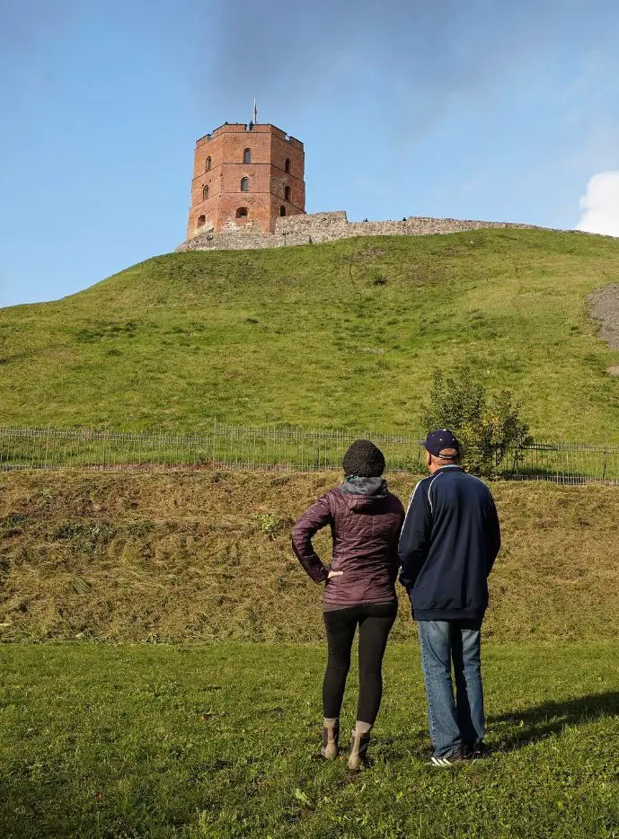 Monica and Peter gazing up at the Gediminas Tower - Lithuania travel guide.