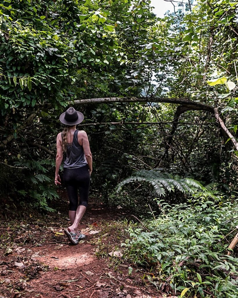 Monica hiking on Moorea in the lush jungle.