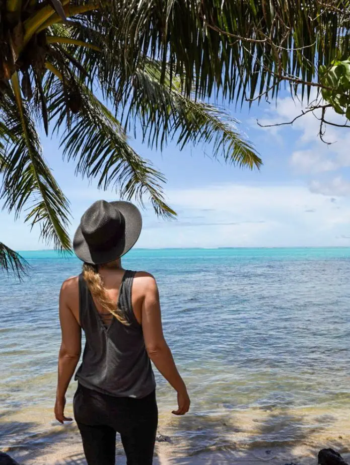 Monica on the white sand beach of Moorea vs. Tahiti's black sand beaches.