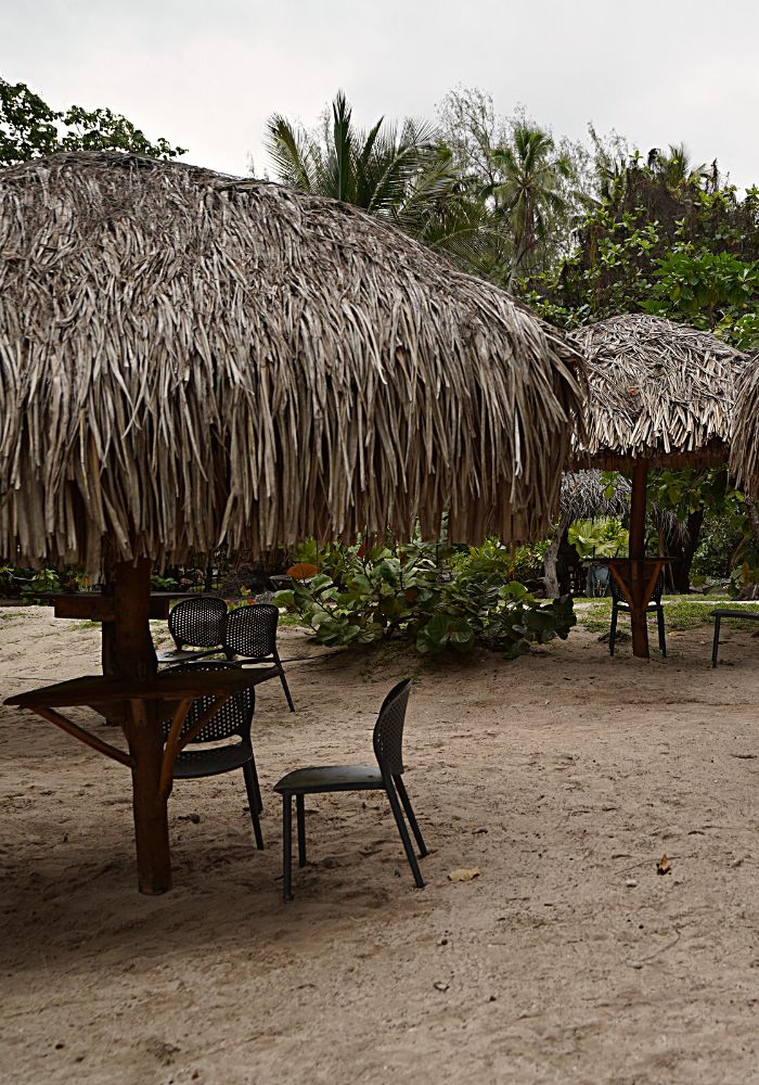 Tables on the sand at the Coco Beach Restaurant, one of the best Things To Do in Moorea, French Polynesia.