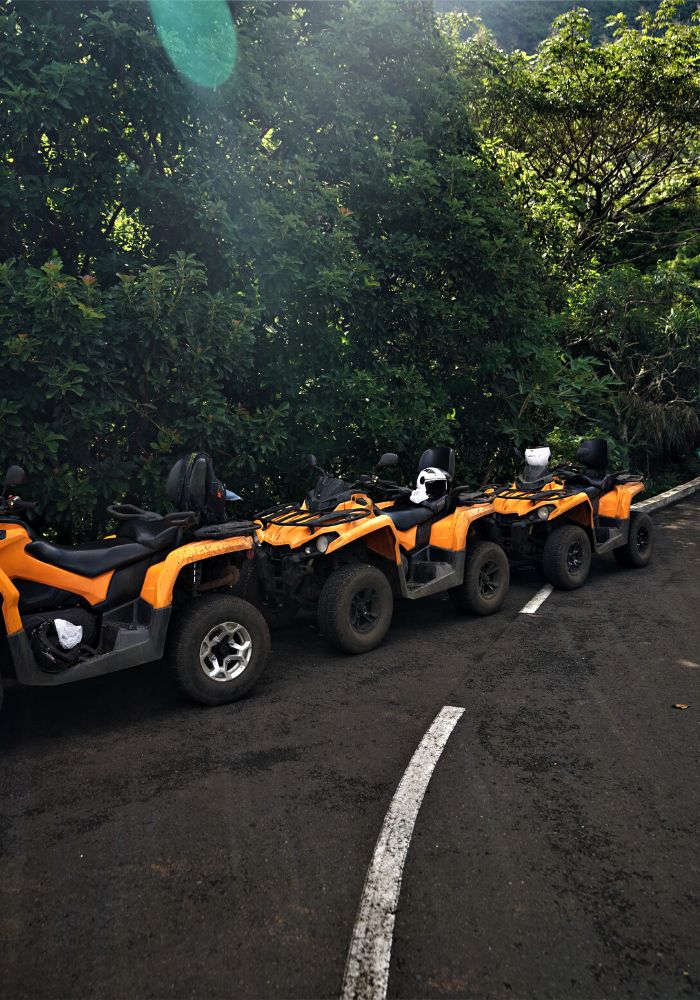 Orange ATVs in the jungle, one of Things To Do in Moorea, French Polynesia.