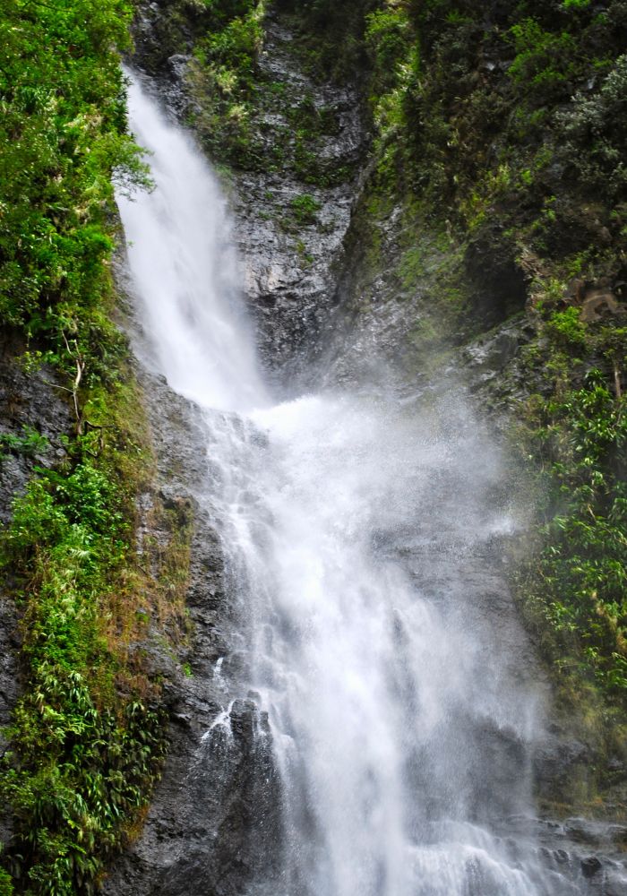 The rushing Afareaitu waterfall, one of the best Things To Do in Moorea, French Polynesia.
