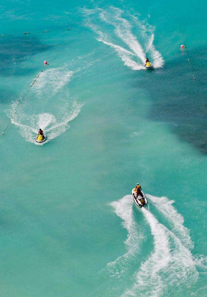Three jet skis on the open ocean, one of the best Things To Do in Moorea, French Polynesia.