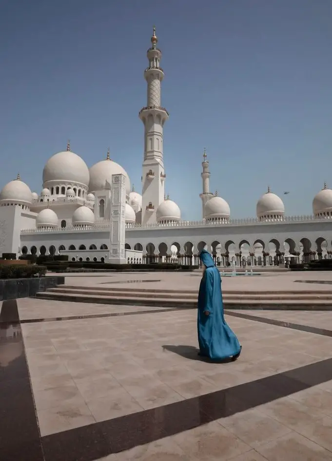 Monica exploring the stark white Sheik Zayed Grand Mosque - United Arab Emirates travel guide.