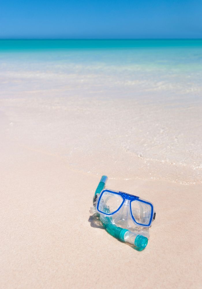 A snorkel mask on the beach in Moorea.