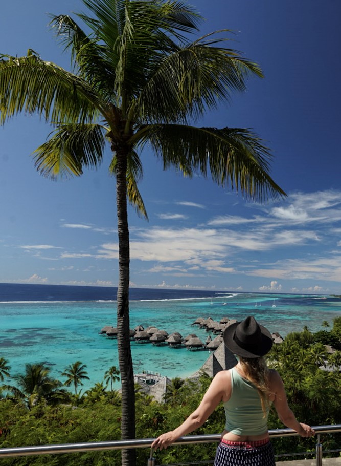 Monica standing over Tamae Beach, one of The Best Places to Snorkel in Moorea.