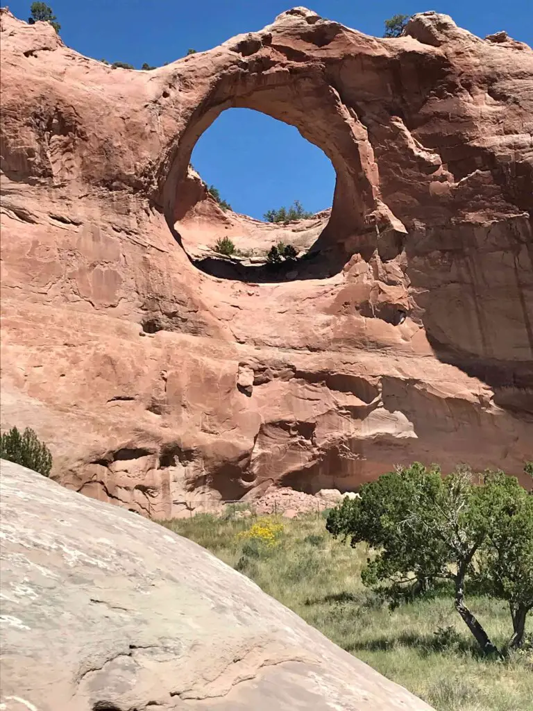 Blue sky showing through Window Rock, one of the best Arizona Bucket List Things To Do.
