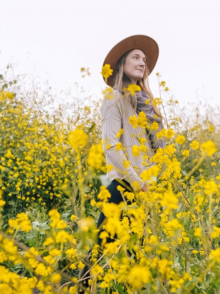 Monica walking the wild mustard of Malibu, one of The Best California Flower Fields.