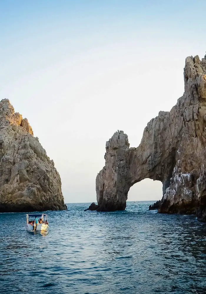 A boat tour of El Arco you can take when choosing between Cancun vs Cabo..