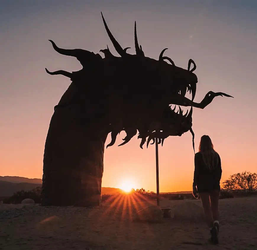 Monica visiting the serpent sculpture at sunrise, one of Things To Do in Borrego Springs, California.