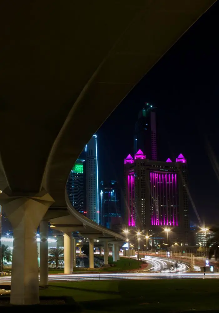 The bright purple and blue lights in Dubai at night - Doha vs. Dubai: Which is Better?