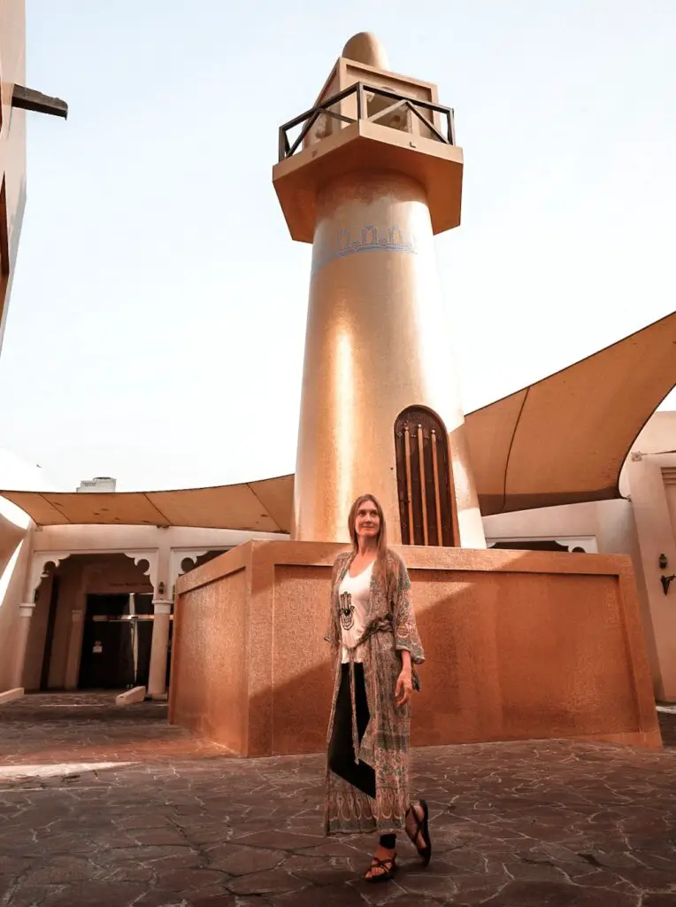 Monica in front of the shiny Gold Mosque - Is Qatar Safe For Women? Solo Female Travel Tips.