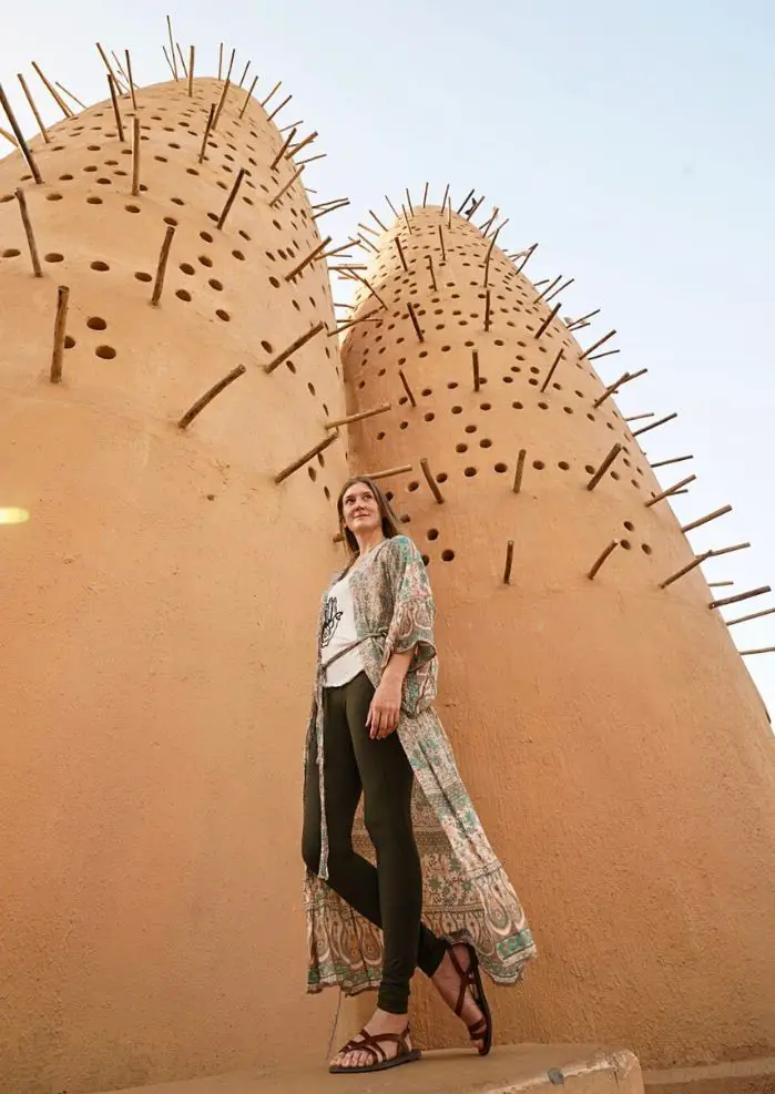 Monica in front of the Pigeon Towers in Doha.