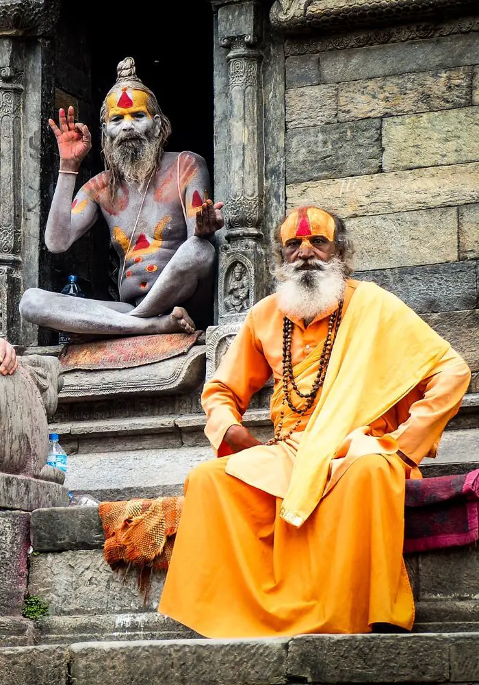 Men in colorful orange robes in Kathmandu - seen while Visiting Nepal.