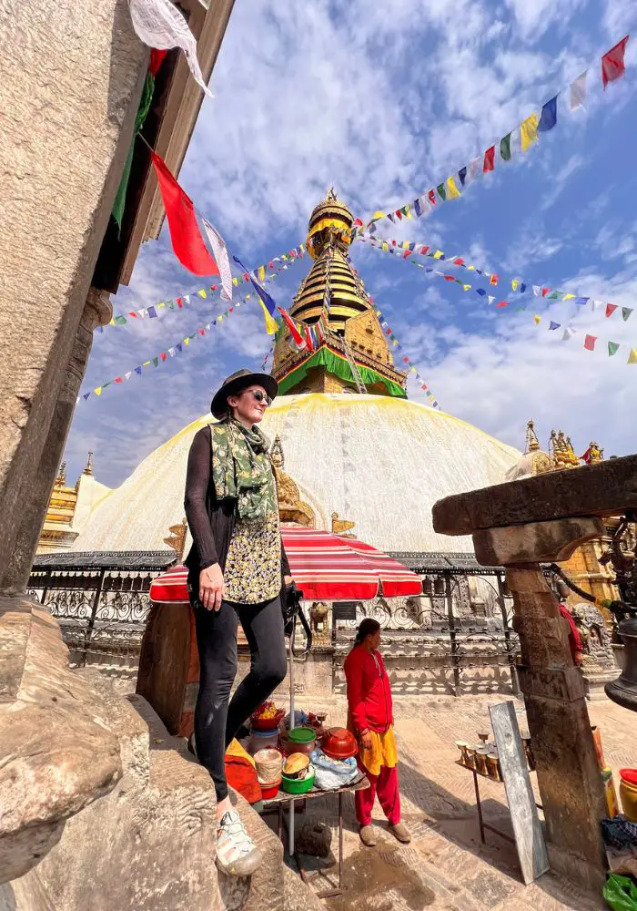 Monica at the Monkey Temple under blue skies while visiting Nepal.