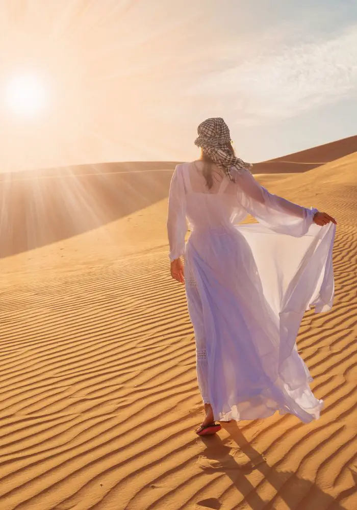Girl walking the dunes on A Liwa Desert Safari.