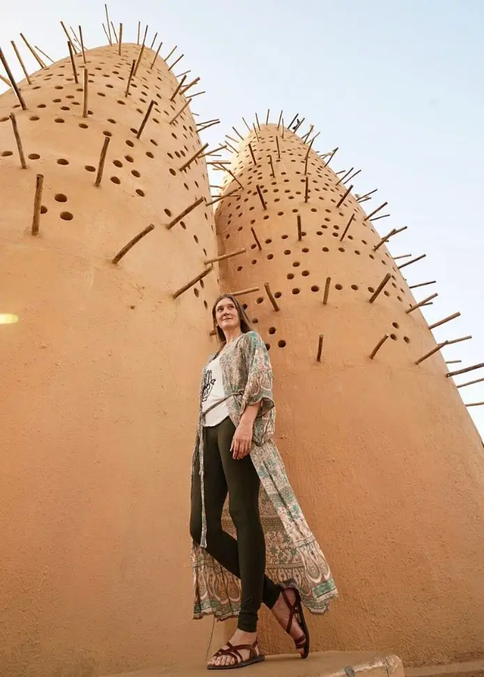 Monica in font of Doha's Pigeon Towers.