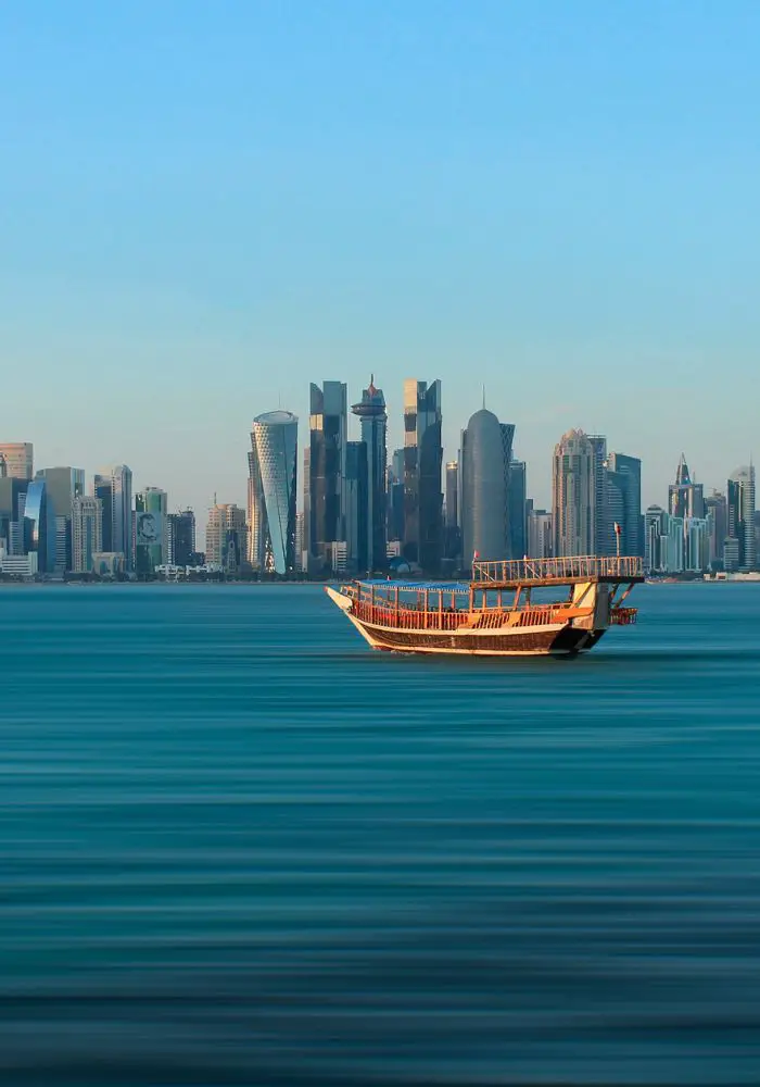 A traditional dhow boat on the blue Persian Gulf.