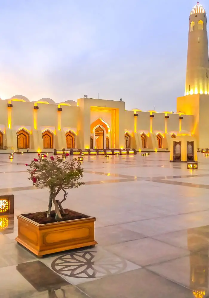 The State Grand Mosque under golden lights, one of the best Places To Visit in Doha, Qatar.
