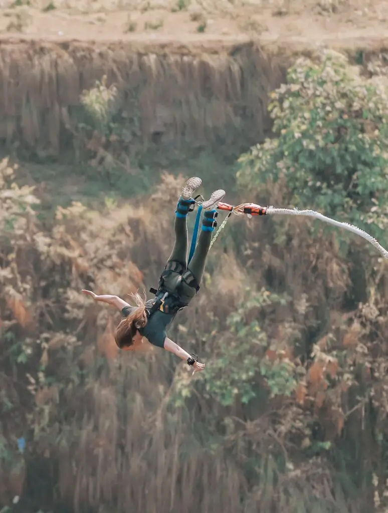 Monica bungee jumping in Nepal - which you can book on The Best Trip Planning Websites for Travelers.