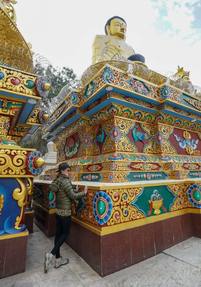 Monica next to the very colorful carvings in Kathmandu - Is Nepal Safe for Solo Female Travel?