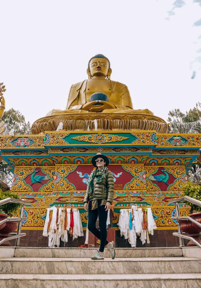 Monica in front of the large Buddha statue - Is Nepal Safe for Solo Female Travel?
