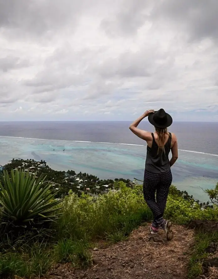Monica standing at the top of Magic Mountain in Moorea, looking out to the ocean.