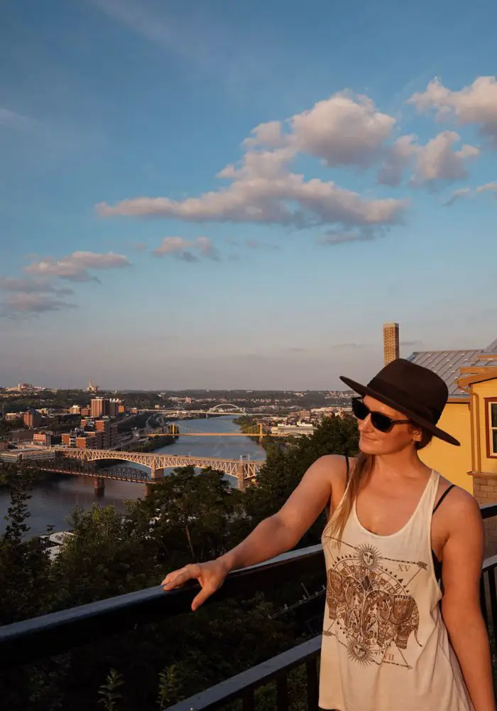 Monica looking out over Mount Washington at sunset - one of the best things to do in Pittsburgh, PA.