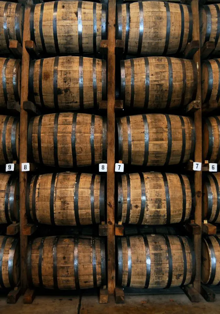 Whiskey barrels lined up and stacked on the whiskey tour, one of the best things to do in Pittsburgh, PA.