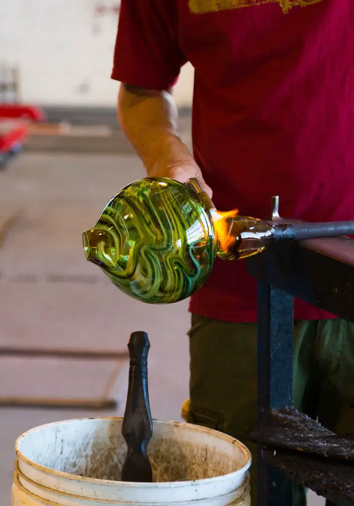 Glassblowing demonstration with colorful green glass, which can be seen at the Pittsburgh glass center, one of the best things to do in Pittsburgh, PA.