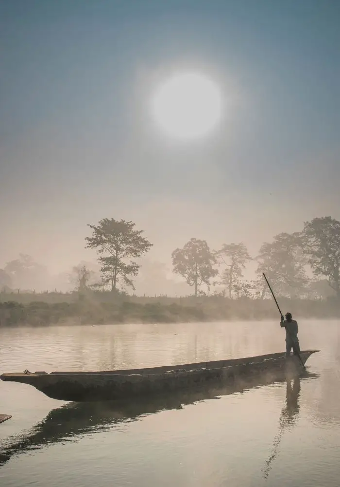 a dugout canoe at sunrise in Chitwan National Park - part of your Chitwna jungle safari.
