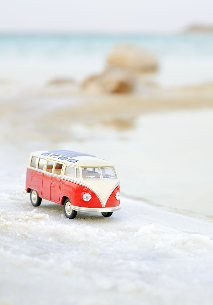A small Aruba bus on white sand.