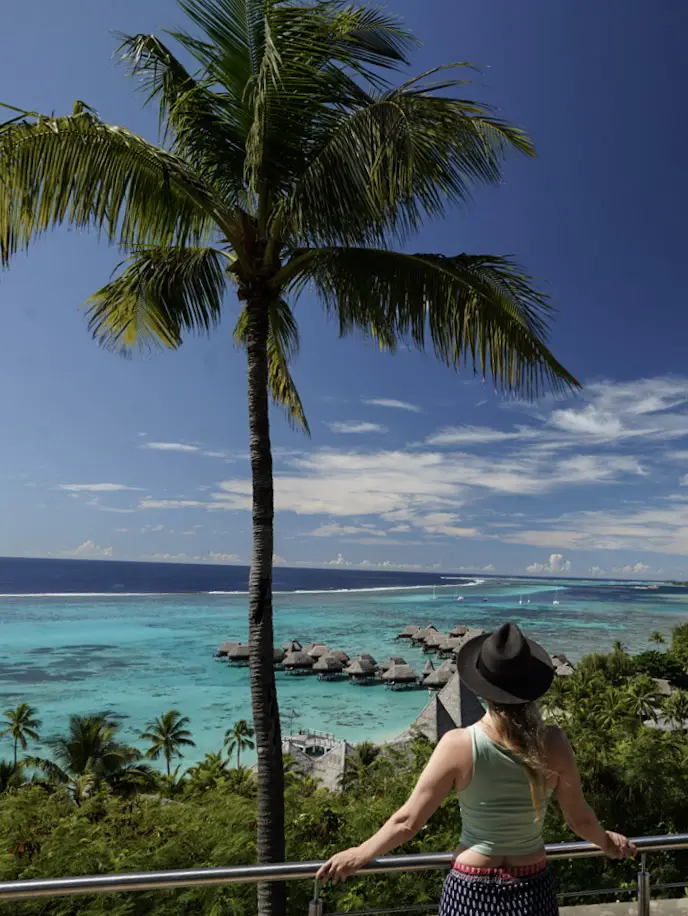 Monica gazing out across the turquoise water and overwater bungalows in Moorea.