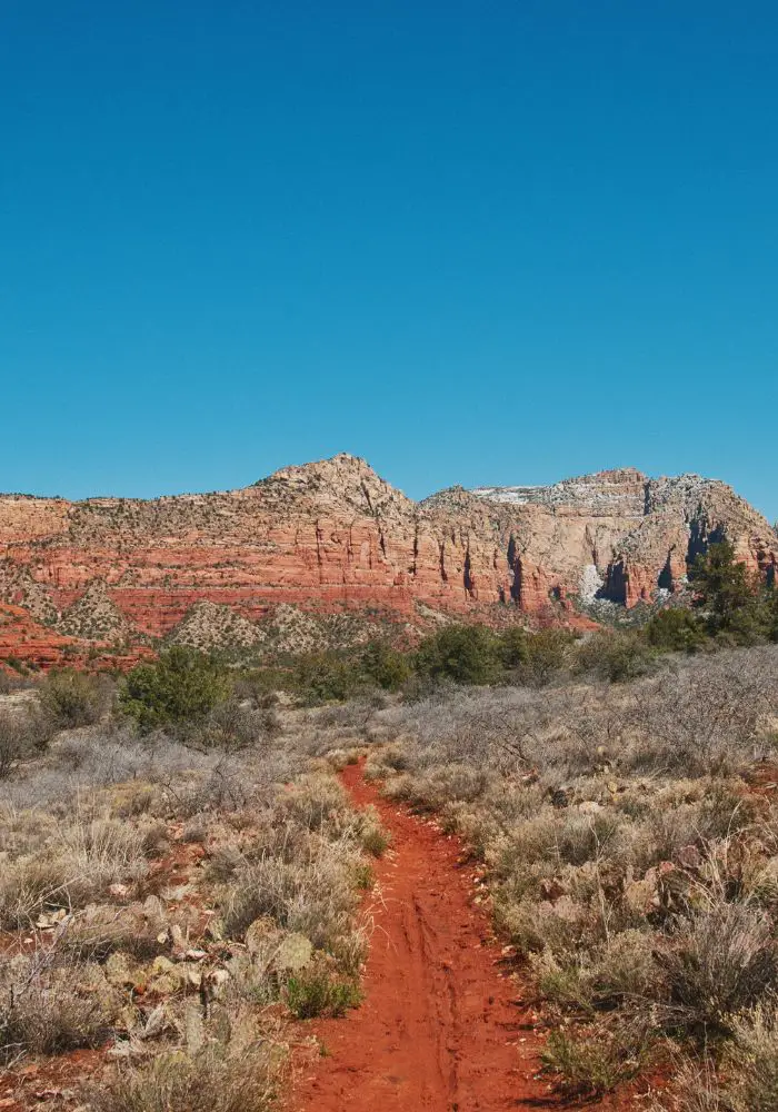 A red hiking trail leading into Sedona's wilderness -  one of the most Unique Things To Do in Sedona, Arizona.