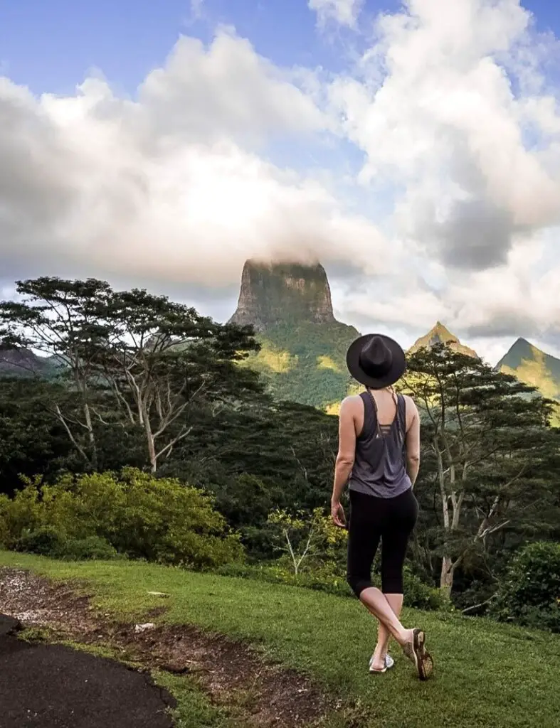 Monica gazing at rugged mountains and misty skies in French Polynesia, Tahiti's country name.
