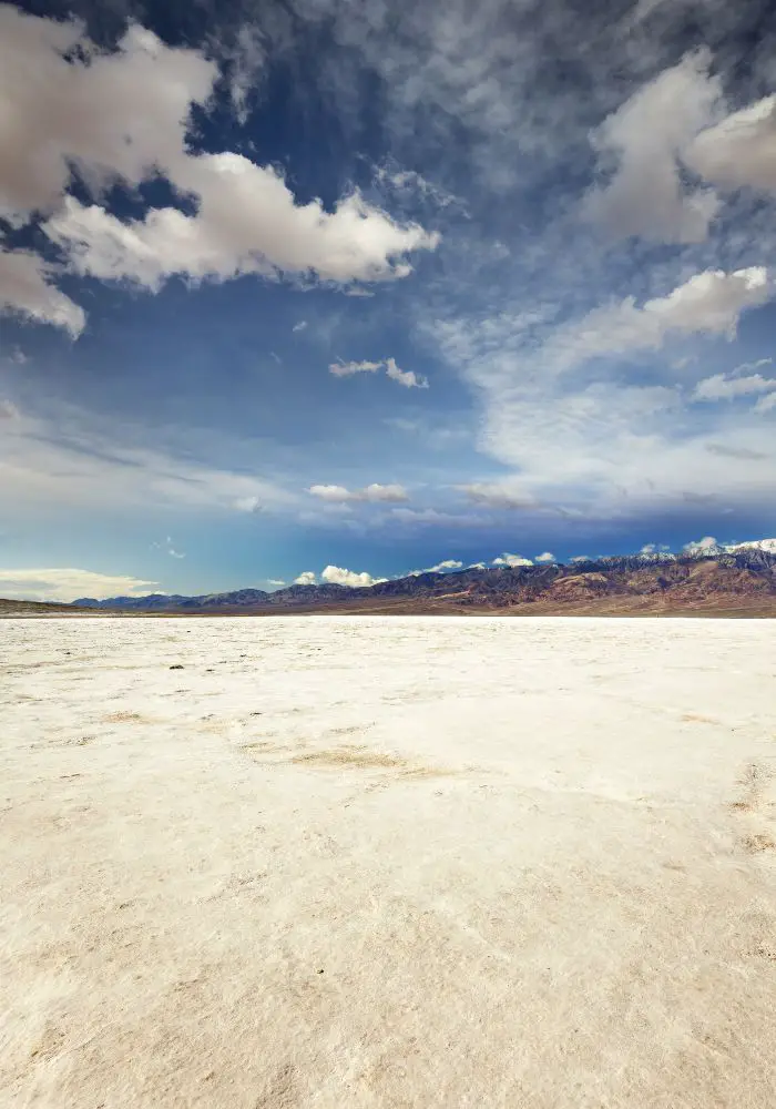 The vast white field of salt at Badwater Basin in Death Valley, one of the best day trips from Palm Springs.